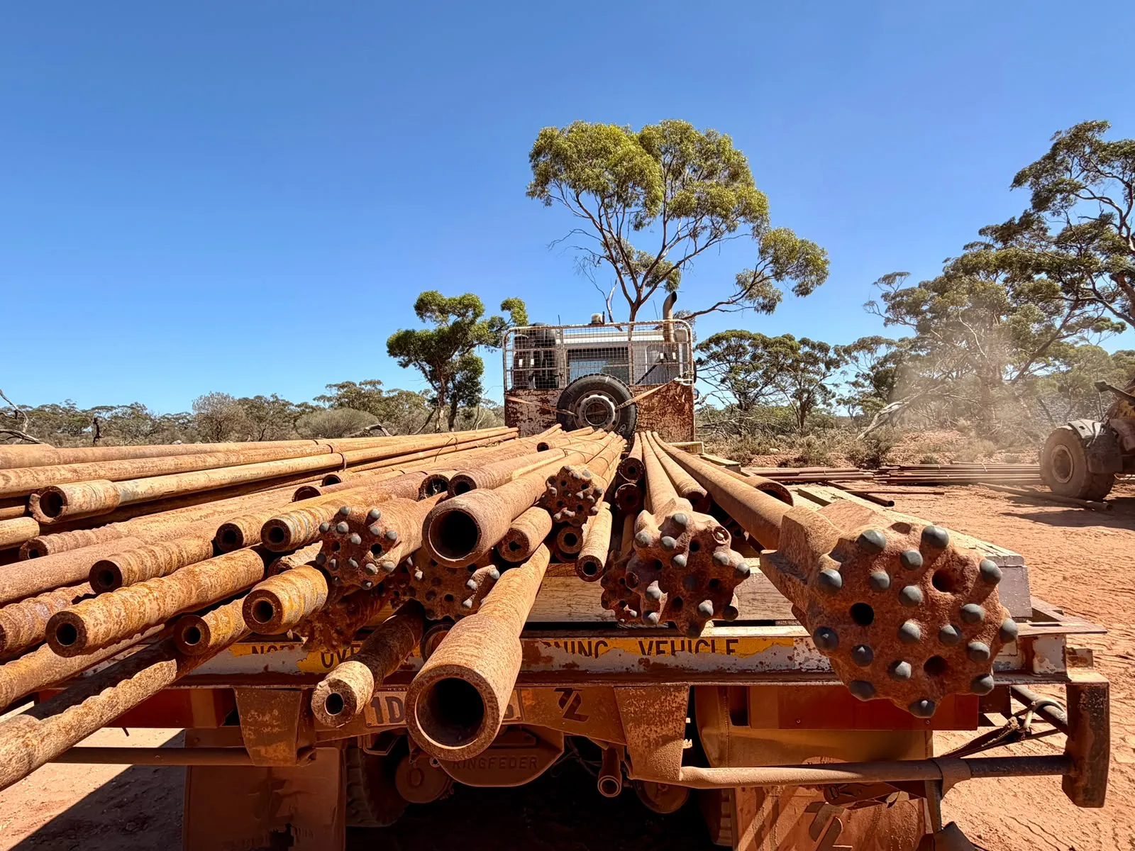 Truck loaded with used drill rods and button bits at a regional WA site