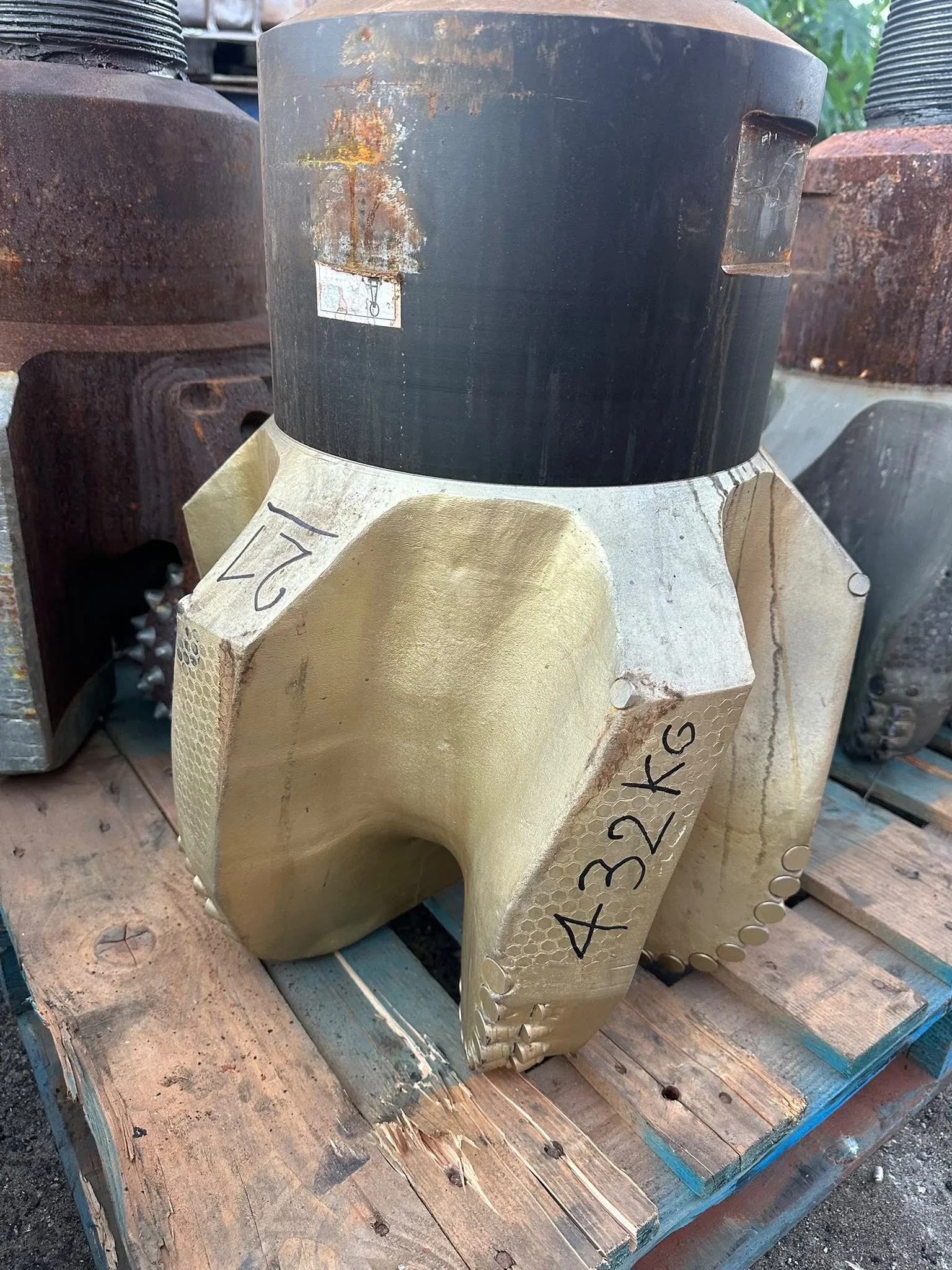 Large PDC drill bit on a pallet awaiting recycling
