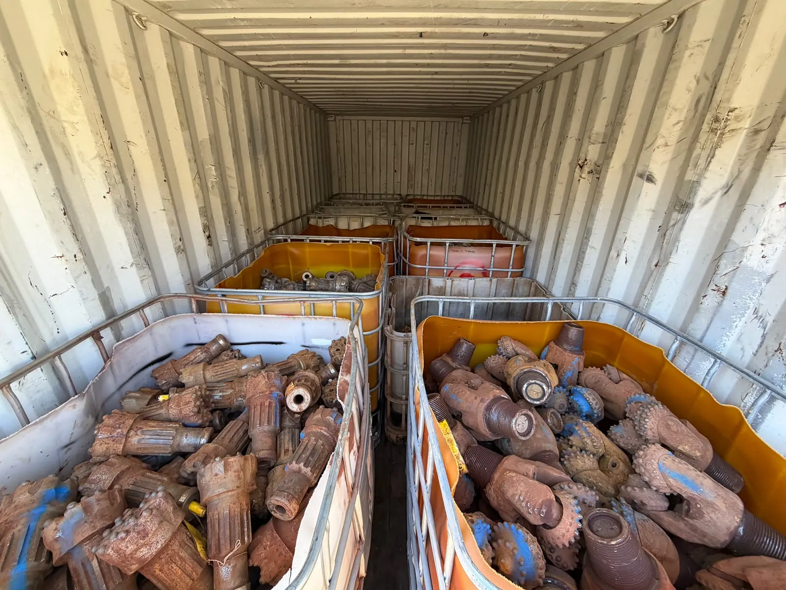 Container totes loaded with tricone and DTH drill bits