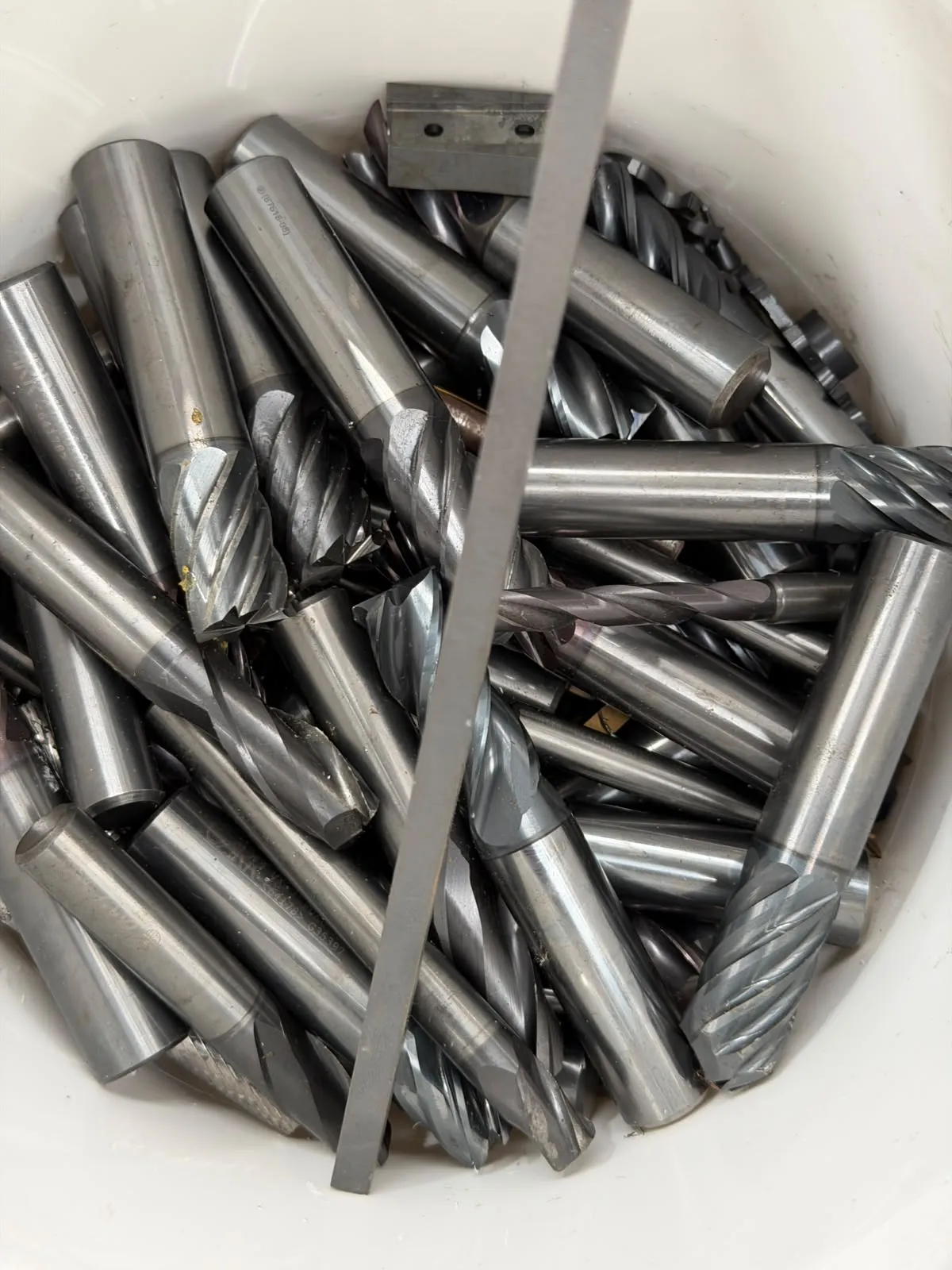 Worn end mills and twist drills in a collection bucket